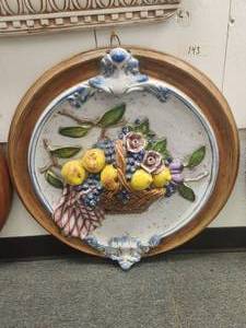 lot 143 image: Large round wall art with raised depiction of basket filled with fruit and flowers -