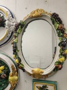 lot 168 image: Beautiful oval shaped wall mirror with raised fruits around the edges - (21 x 26)