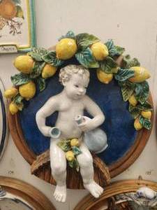 lot 176 image: Amazing large wall art of baby complimented by lemons. Aged crackling sets off this baby against a blue background and terra cotta colored rim - (27)
