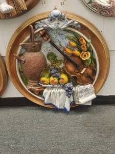 lot 185 image: Artist signed large round wall art of raised violin, flowers, and a pitcher with terra cotta colored rim (27)