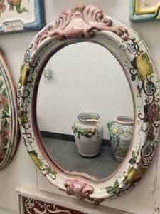 lot 192 image: Artist signed oval mirror with hand painted lemons, grapes, and pomegranates with a pink trim (21 x 26)