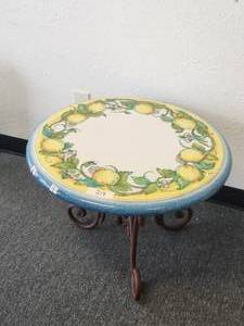 lot 219 image: Clay tabletop with hand painted lemons and a light-blue trim - includes iron base - (18 x 27)