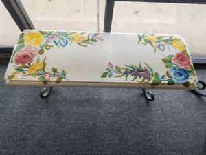 lot 222 image: Clay hand painted garden bench adorned with pastel-colored flowers. includes galvanized iron base - (17 x 19 x 48)