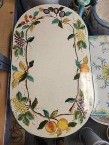 lot 187 image: Oval shaped lava and clay tabletop with hand painted fruits and antiqued crackling on an off-white background (23 x 40 x 33)-Table base included - Signed by the artist in Deruta, Italy - Includes base -