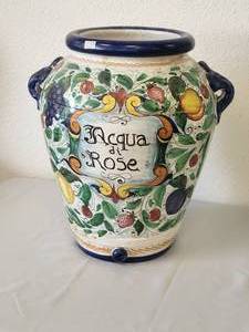 lot 201 image: Iron stand with ceramic top adorned in hand painted lemons supports a beautiful rose water urn that is also hand painted with various fruits. All 3 pieces are included