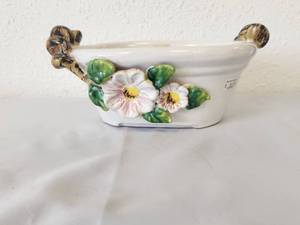 lot 223 image: Small ceramic dish with raised floral design and handles that mimic stems (3 x 9)