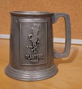 lot 12 image: VINTAGE 1983 PLANTERS PEWTER-STYLE MUG AS SHOWN.