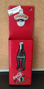 lot 60 image: COCA-COLA BOTTLE OPENER WITH BOTTLETOP CATCHER IN STYLE SHOWN. MADE IN MEXICO.
